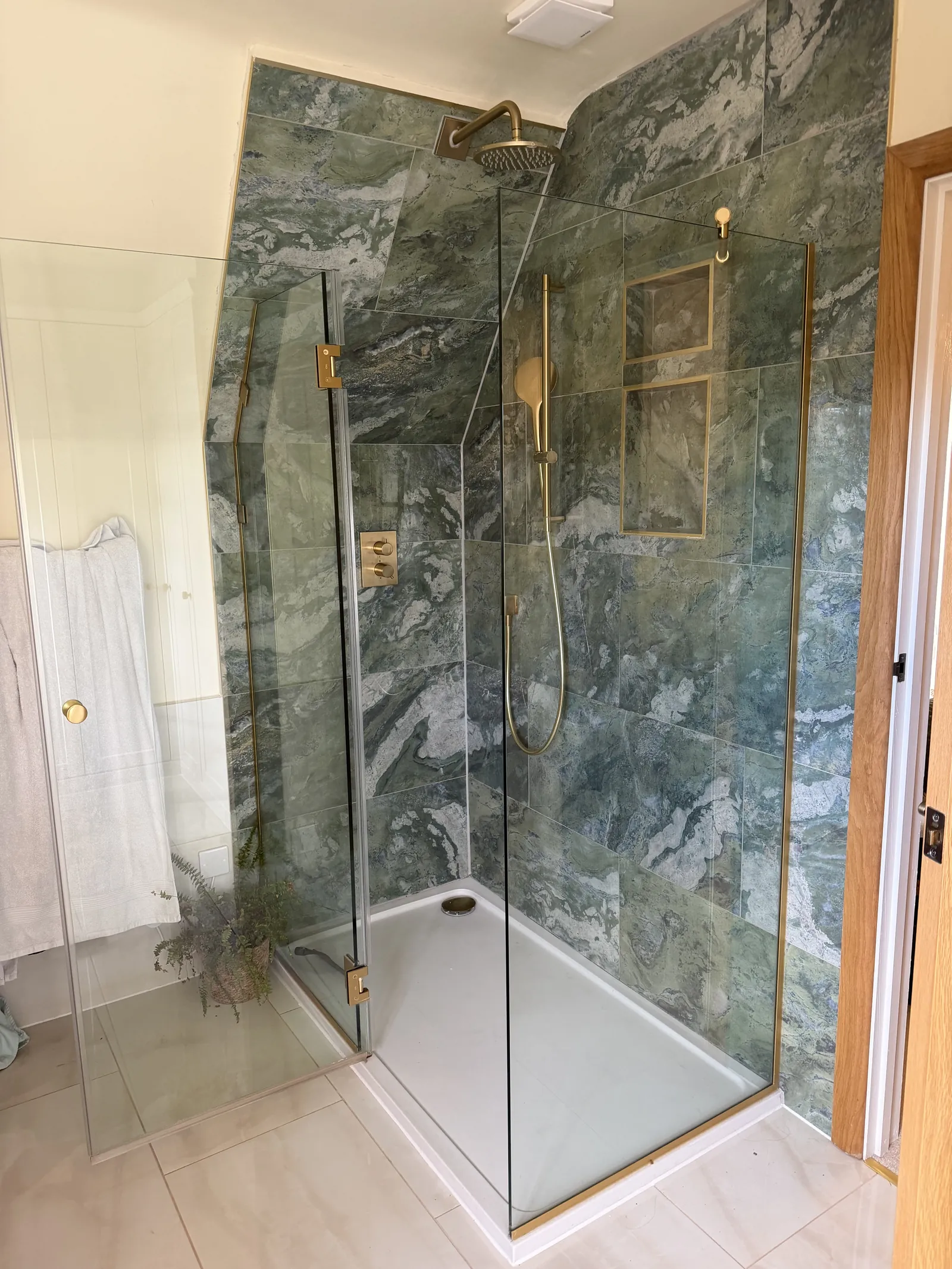 Frameless walk-in shower with floor-to-ceiling tiling