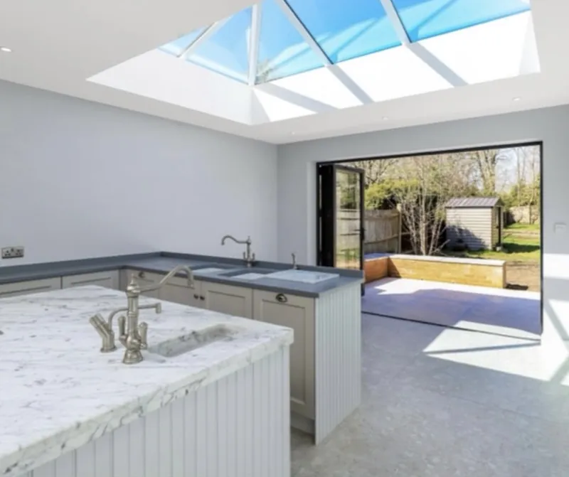 Kitchen with marble island under a roof lantern
