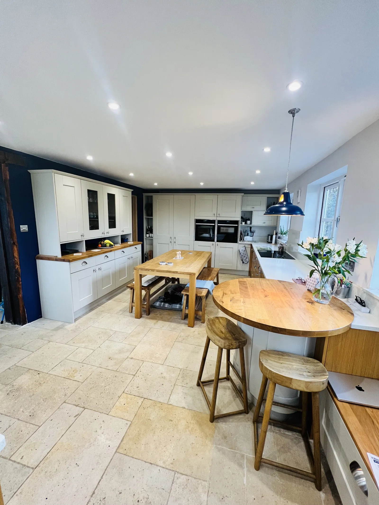 Shaker kitchen with oak dining table and stone floor